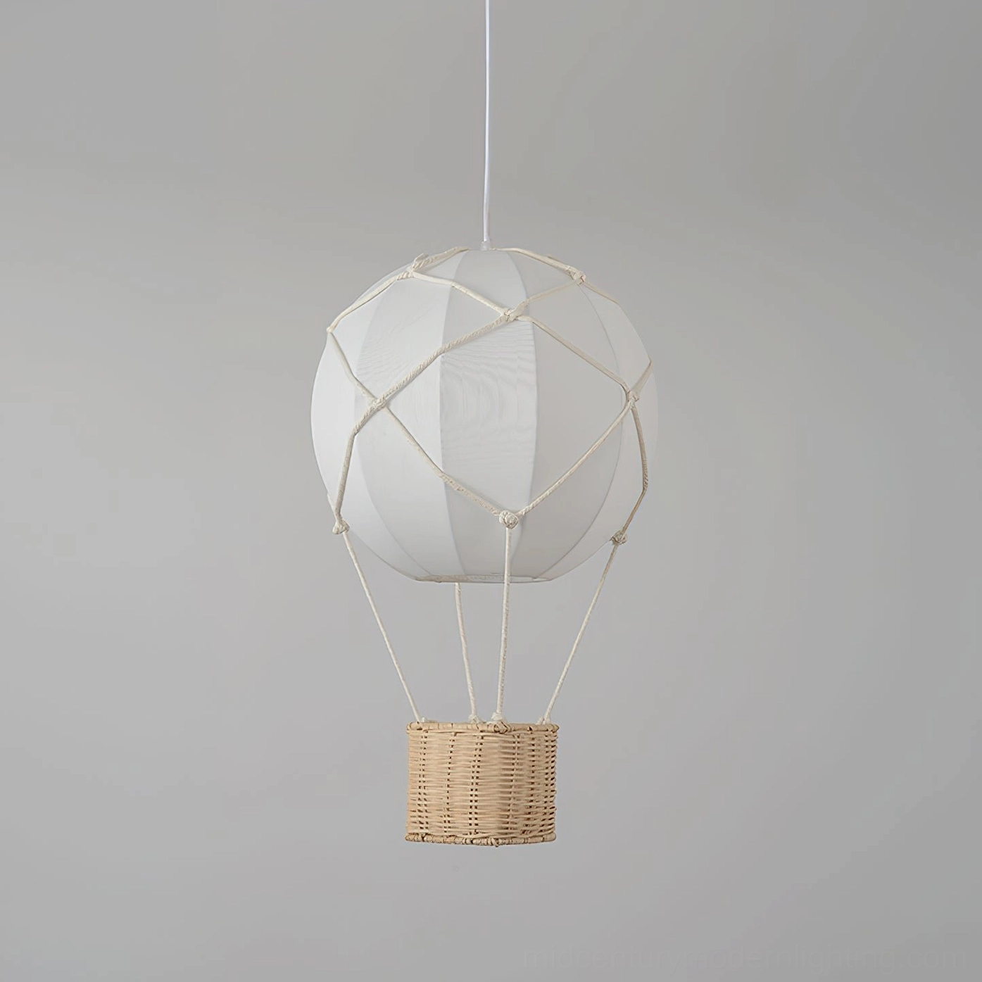 Hot air balloon pendant light frontal close-up showcasing all-white fabric shade with woven rattan basket base