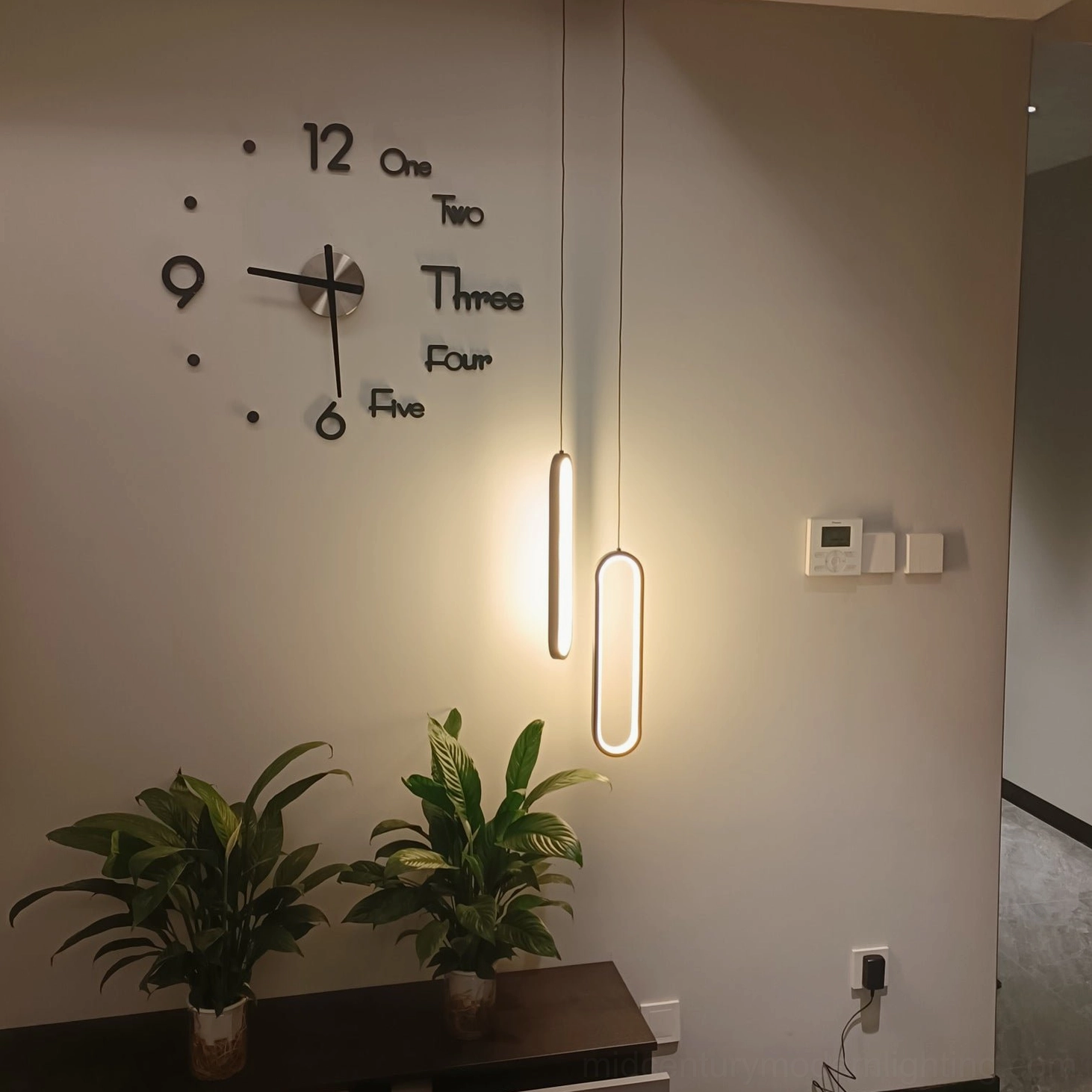 Huron double vertical oval pendant lights modern hallway with decorative wall clock potted plants