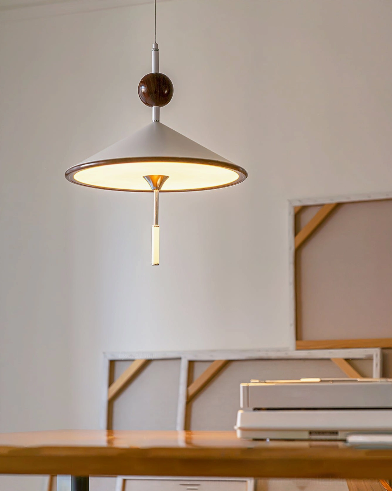 Illuminated alien pendant lamp creating warm ambient glow in art studio environment
