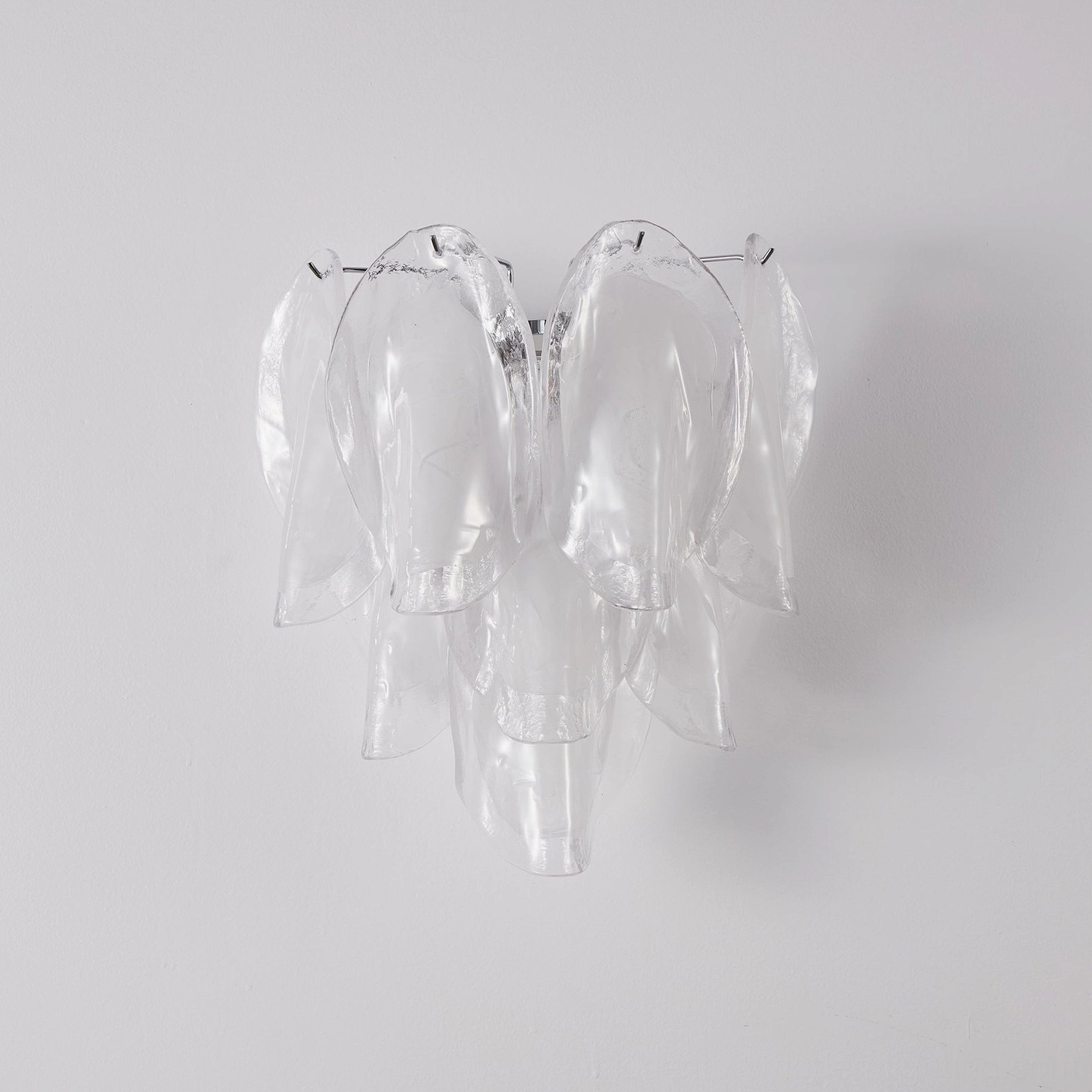 Ina sculptural wall light unlit displaying clear and frosted white glass petals with polished chrome frame