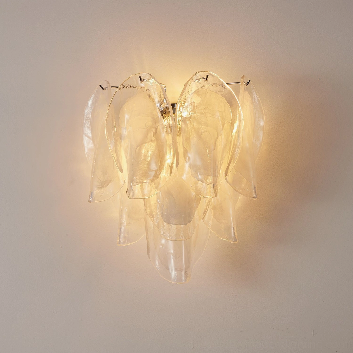 Ina wall light close-up of stacked transparent glass petals construction detail