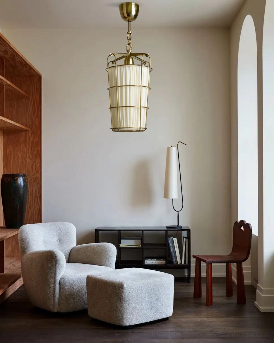 Modern caged pendant suspended in contemporary living room with neutral tones, fabric sofa and wooden furniture