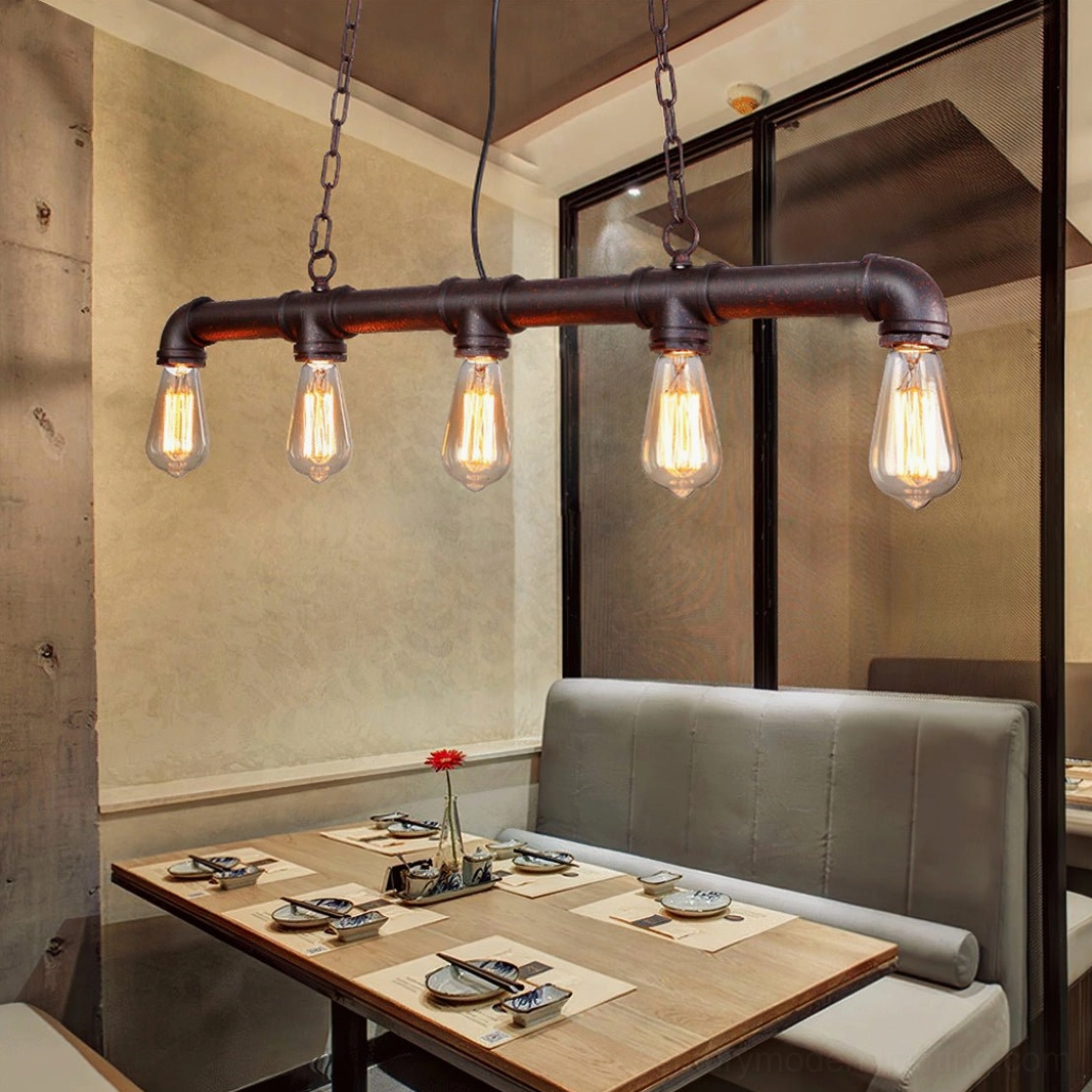 5-bulb industrial pipe pendant light creating warm ambiance in restaurant booth dining area