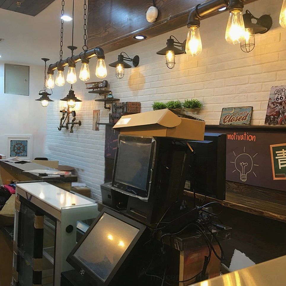Industrial pipe pendant lighting fixtures displayed in cozy retro cafe checkout counter
