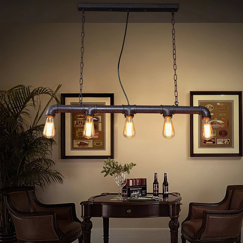 Dual linear industrial pipe pendant lights in home lounge dining area with warm vintage decor