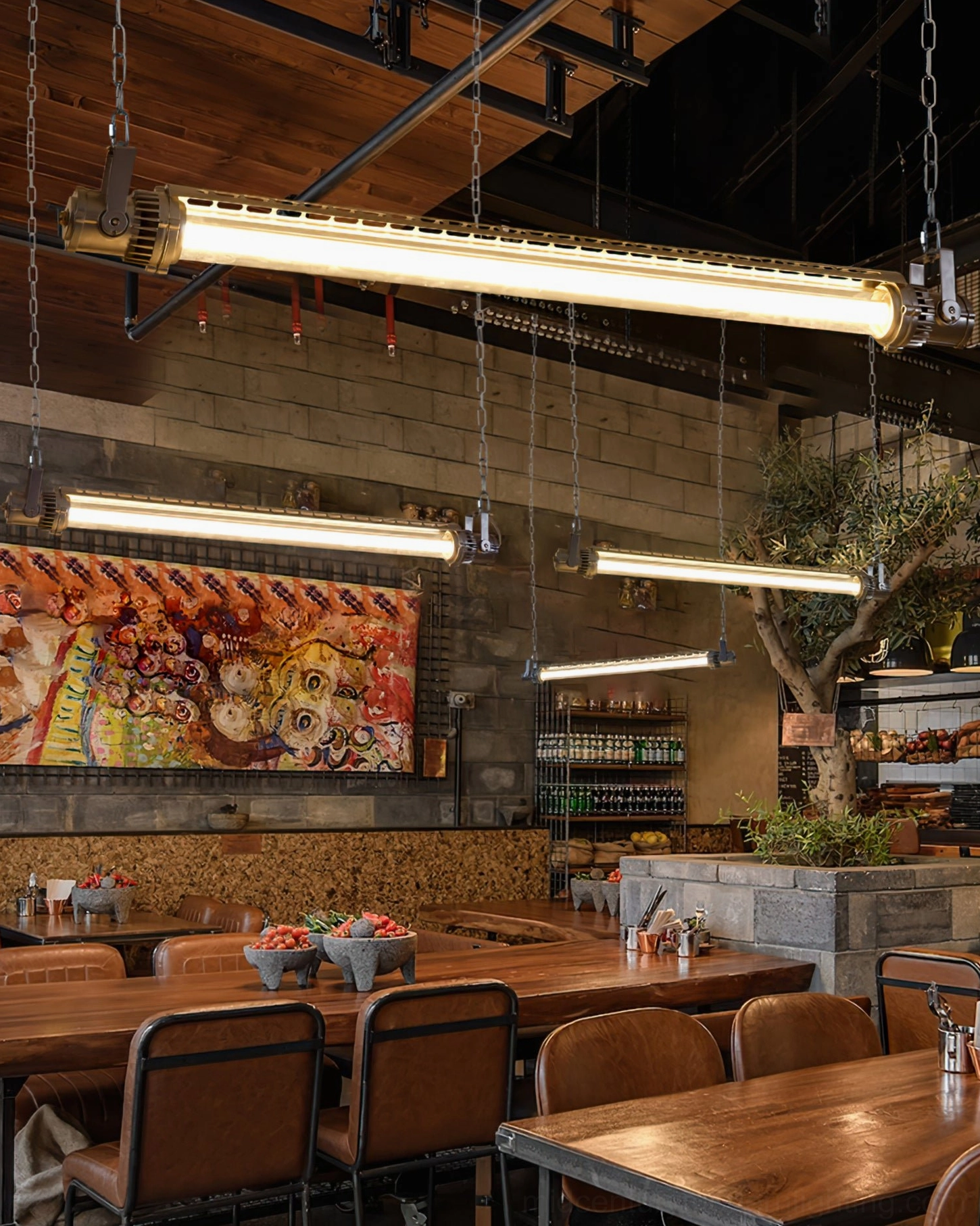 Large rustic restaurant interior with multiple industrial silver tube pendant lights, low wide-angle ambient view