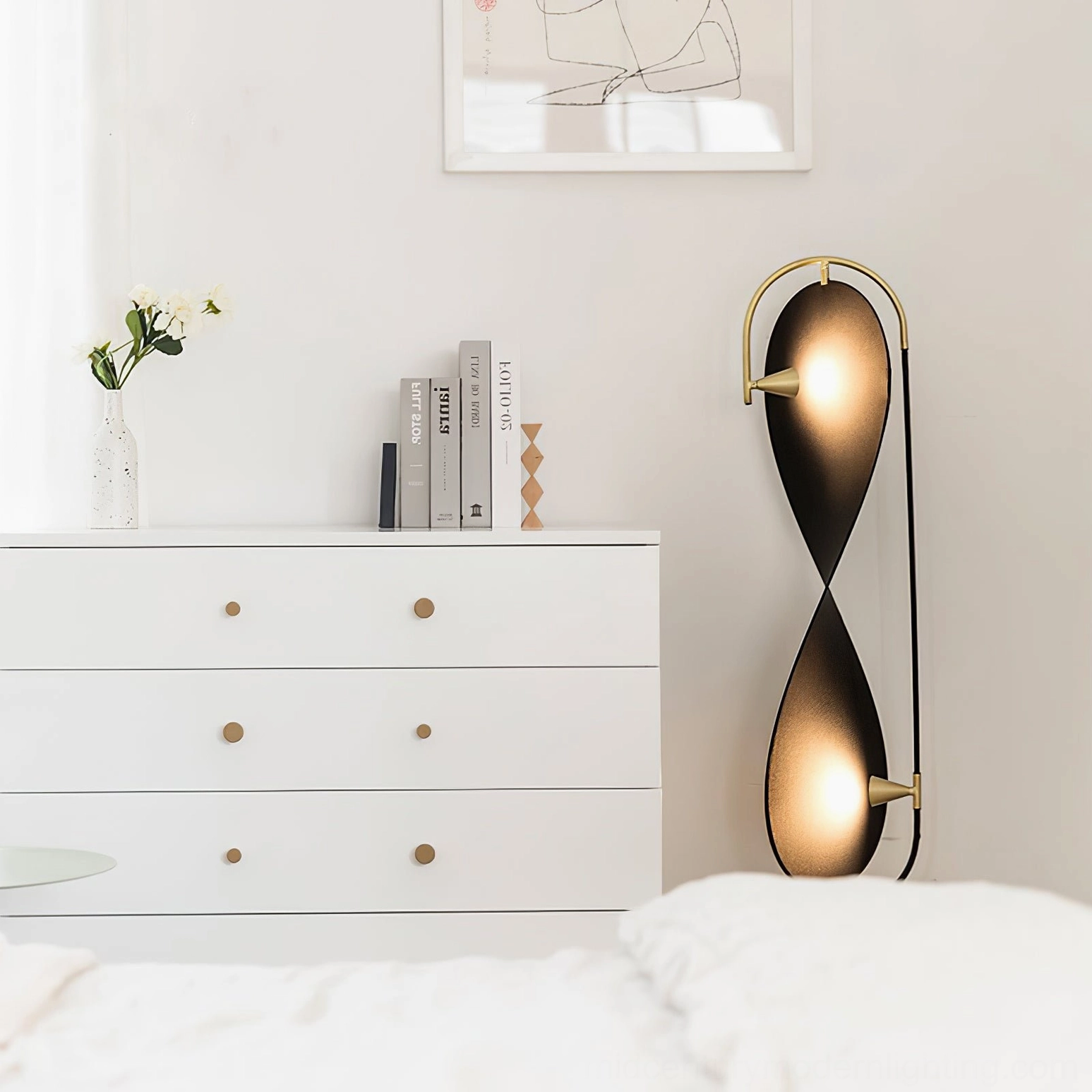 Infinite Floor Lamp positioned in modern minimalist bedroom with black and gold finish creating warm ambient atmosphere