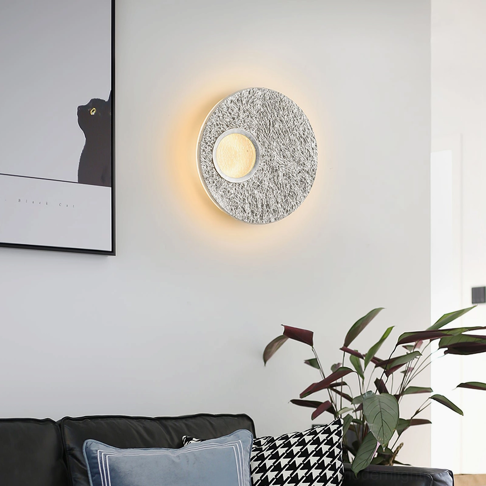 Silver Infinity modern wall light in contemporary living room with minimalist potted plant and home accents