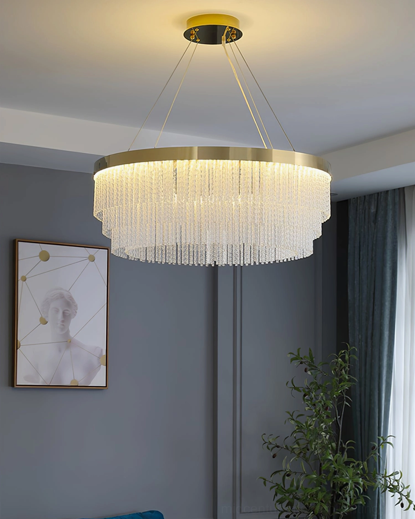 Crystal pendant chandelier with cascading tassels installed in contemporary living room with wall art