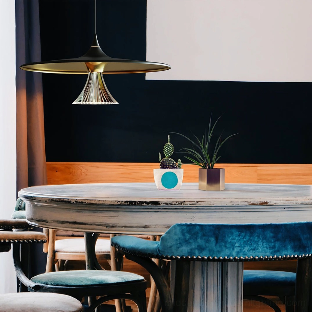 Ipho black and gold disc pendant lamp above round dining table in contemporary cafe setting