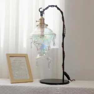 Modern iridescent resin drip table lamp three-quarter view with black twisted metal stand on tabletop