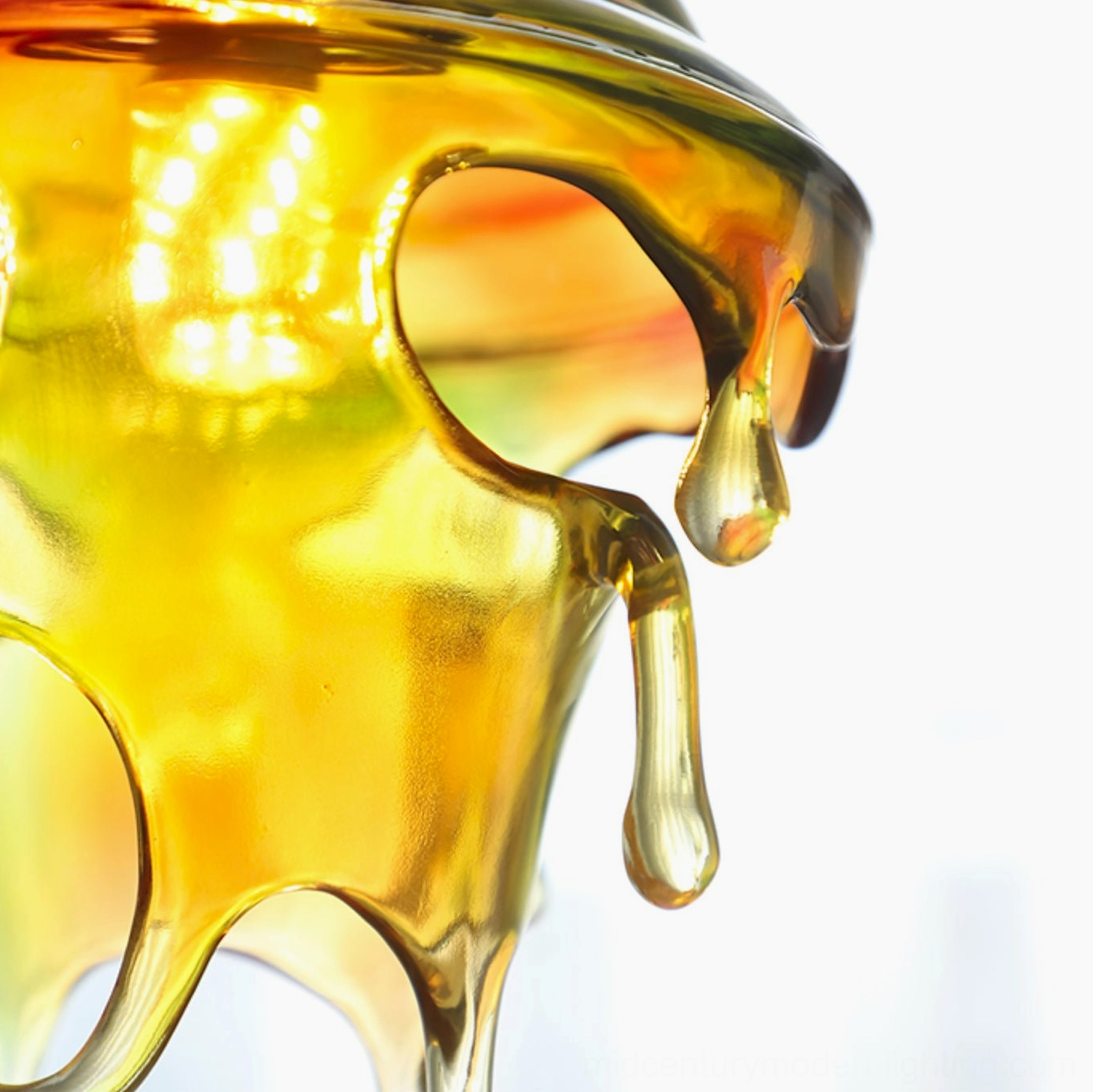 Extreme close-up of amber iridescent resin droplet texture and molten-shaped details