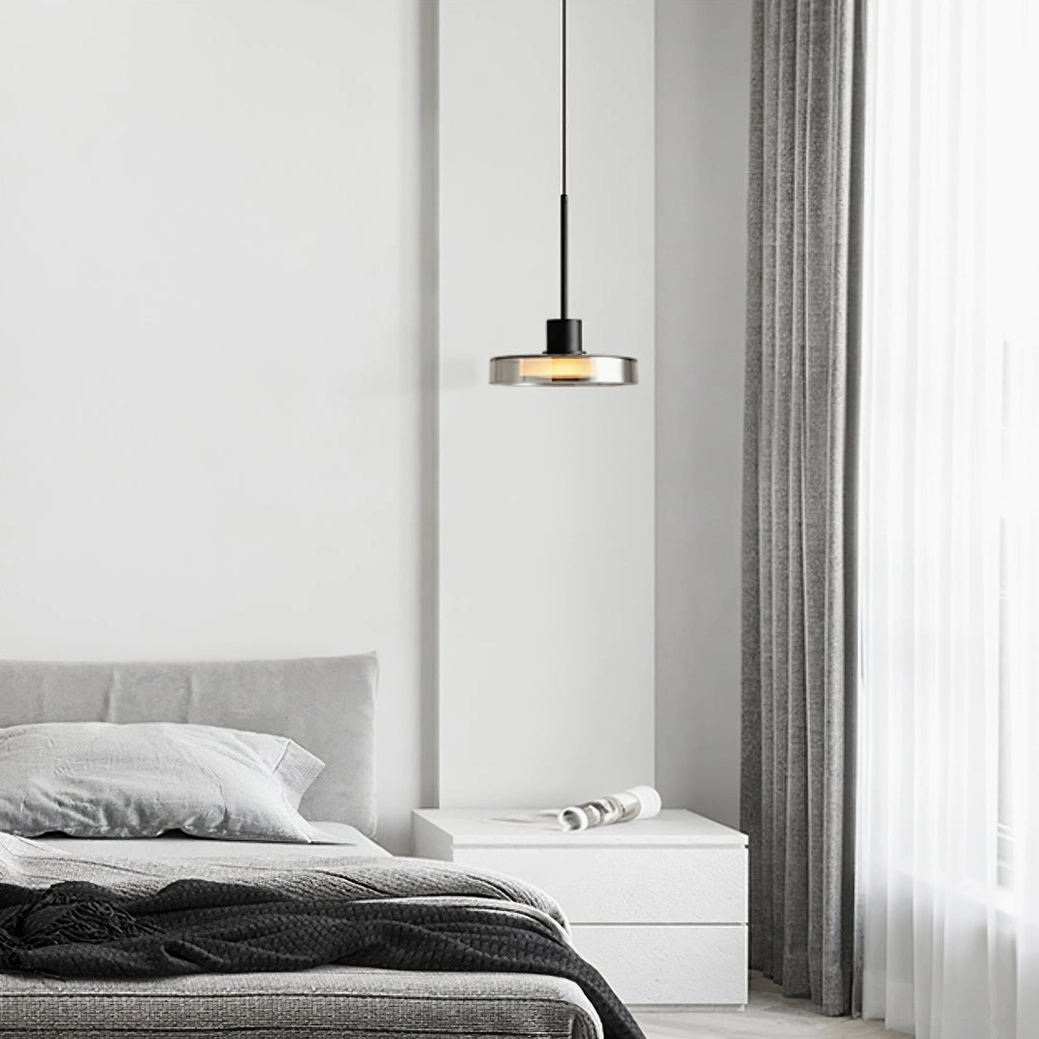 Minimalist Iris pendant fixture with smoke grey glass in monochromatic bedroom design