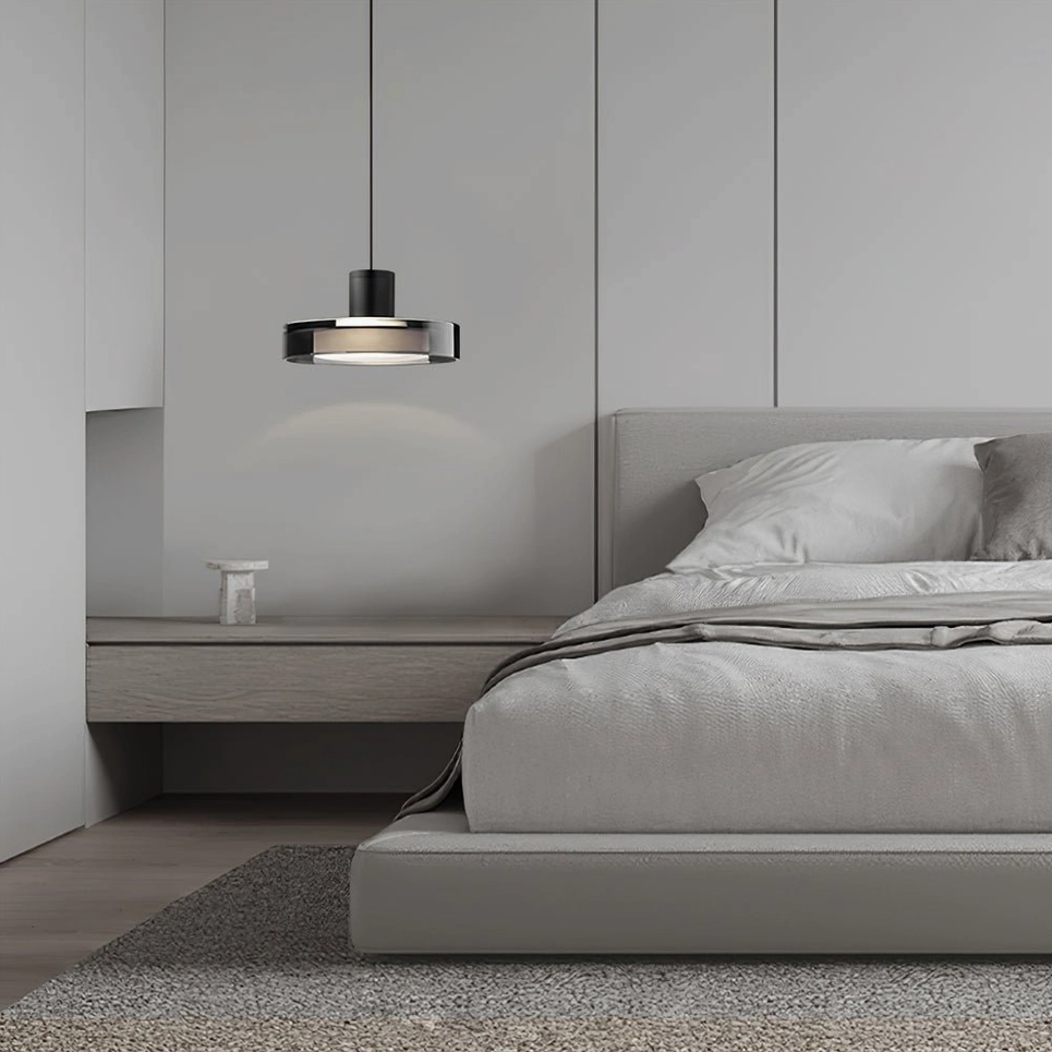 Iris pendant light above desk in modern bedroom with neutral tones and wood accents