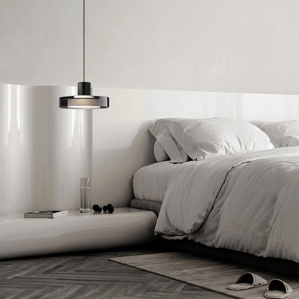 Single Iris pendant light in minimalist modern bedroom with soft warm illumination