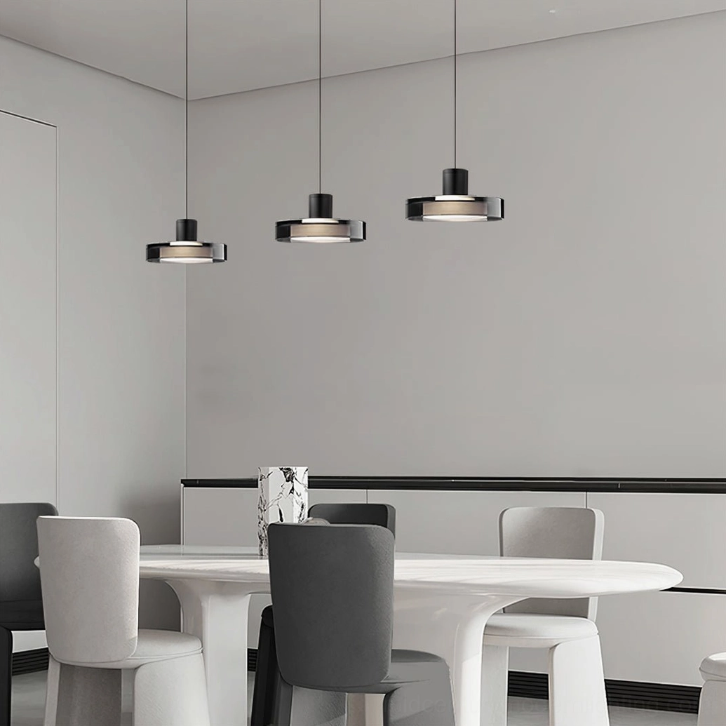 Multiple Iris pendant fixtures in bright white contemporary dining space with dark metal contrast