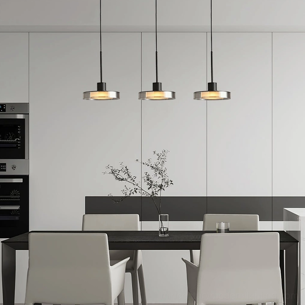 Three-head Iris pendant cluster installed over modern dining room table with warm lighting