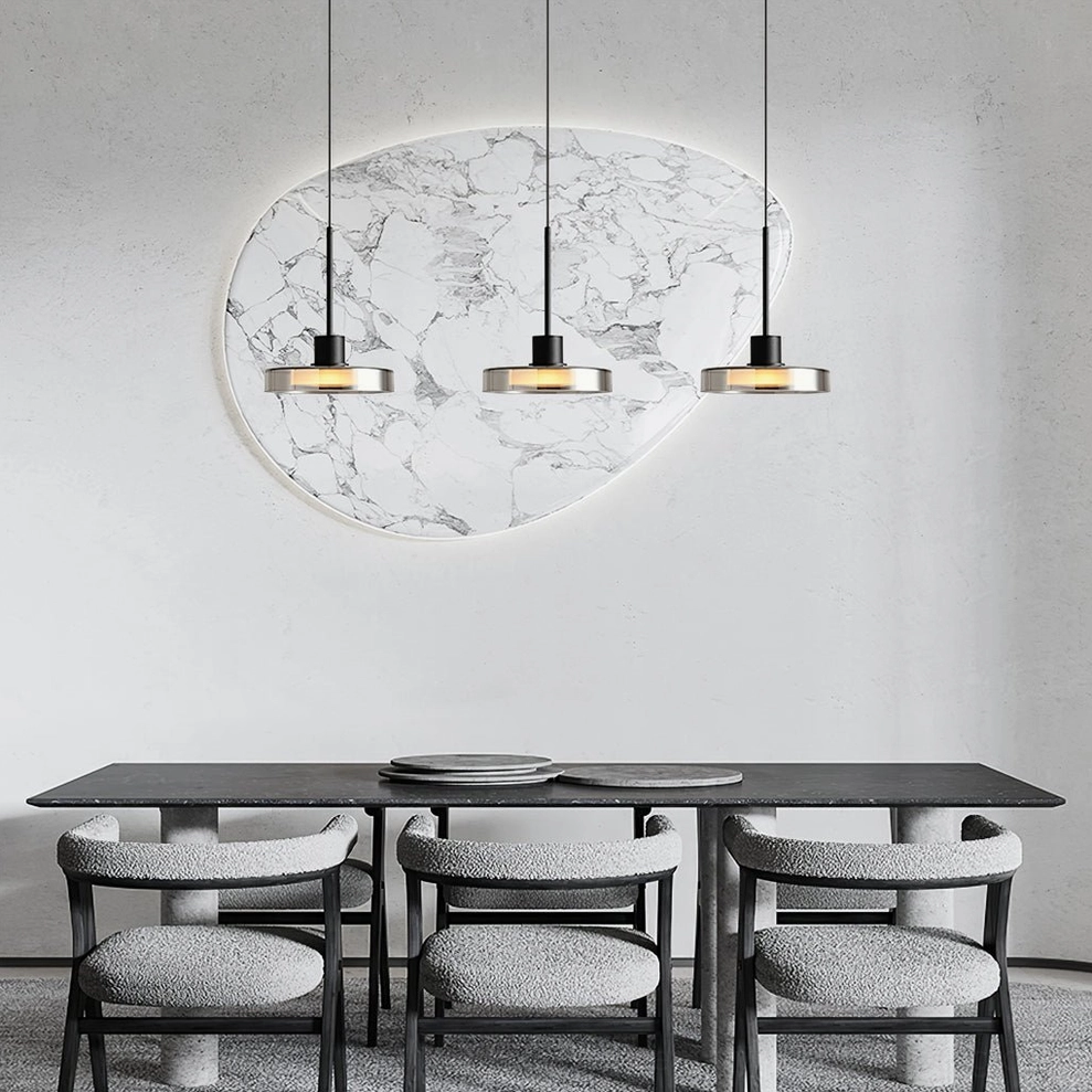 Three-head Iris pendant cluster over dining area with marble wall art and luxury minimalist decor