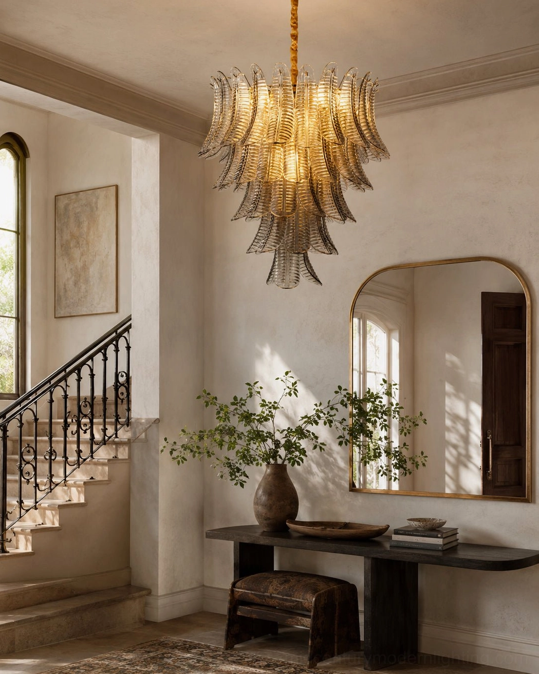 Tiered glass chandelier in traditional elegant hallway foyer with minimalist neutral warm home decor