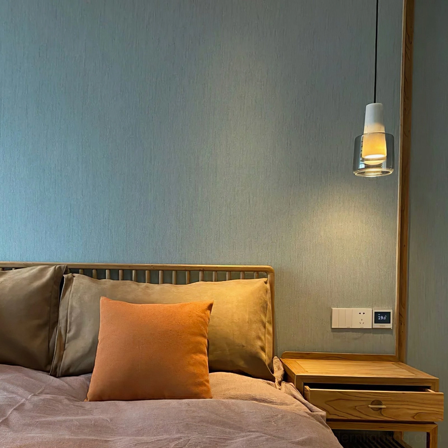Issa hanging pendant lamp in modern wooden bedroom with warm bedside lighting setup