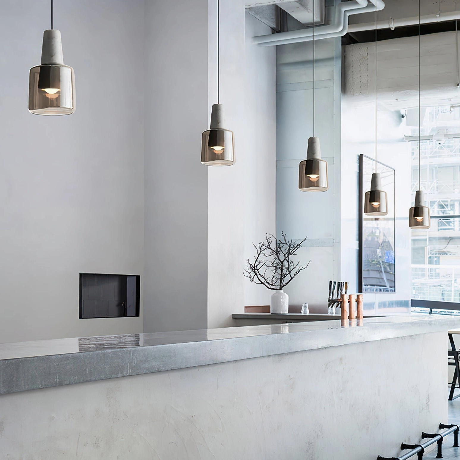 Multiple Issa pendant lamps installed over kitchen island bar counter industrial minimalist style