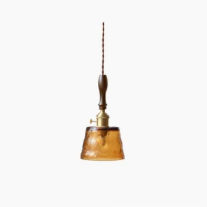 Jace amber glass pendant lamp with walnut wood handle and brass hardware, front studio view