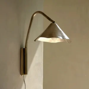 Janna mid-century modern plug-in wall light illuminated in warm home interior, eye-level view