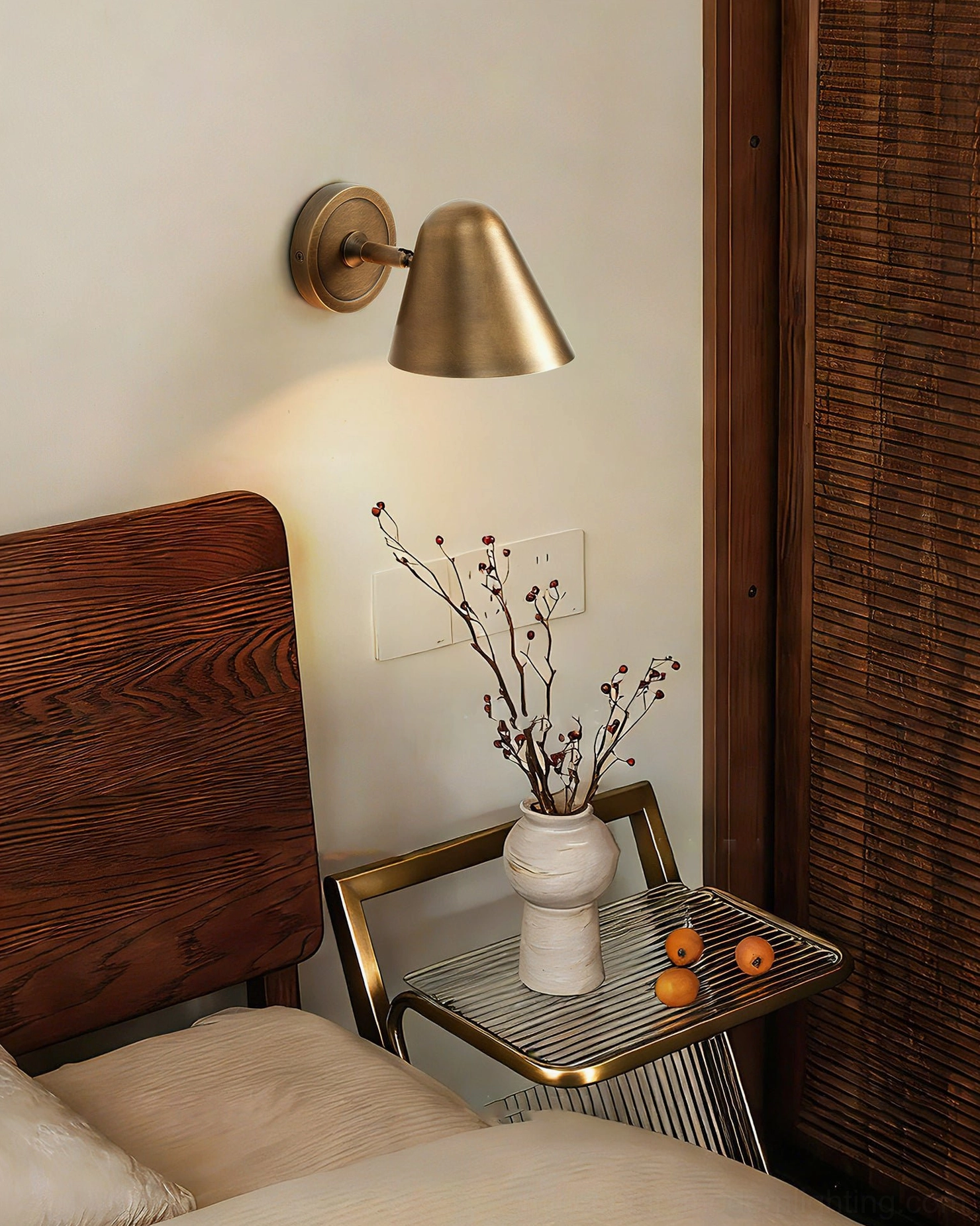 Janna Wall Sconce in minimalist bedroom with dried flowers - warm brass retro lighting