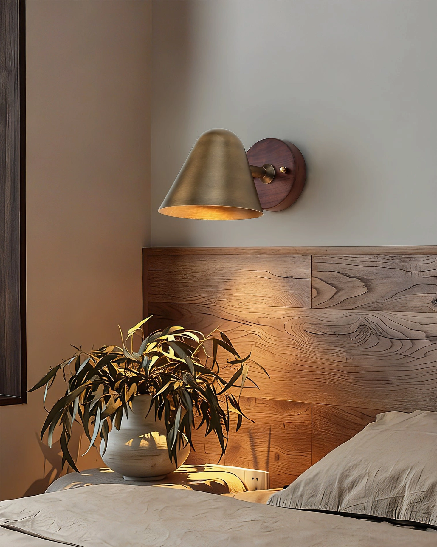 Janna Wall Sconce with Walnut backing installed in modern bedroom - cozy mid-century lighting