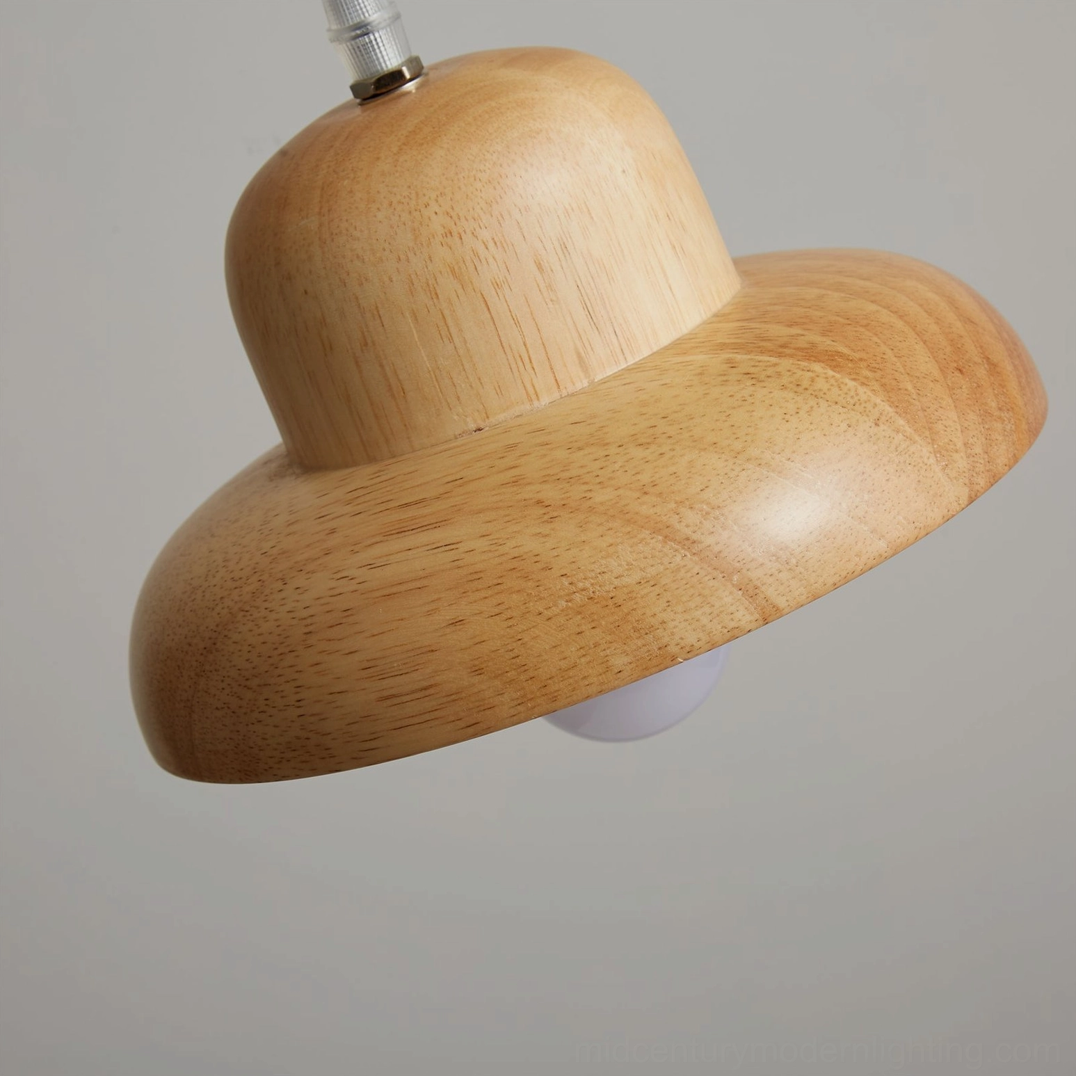 Japanese wooden pendant light creating warm ambient lighting in modern living space with natural elements