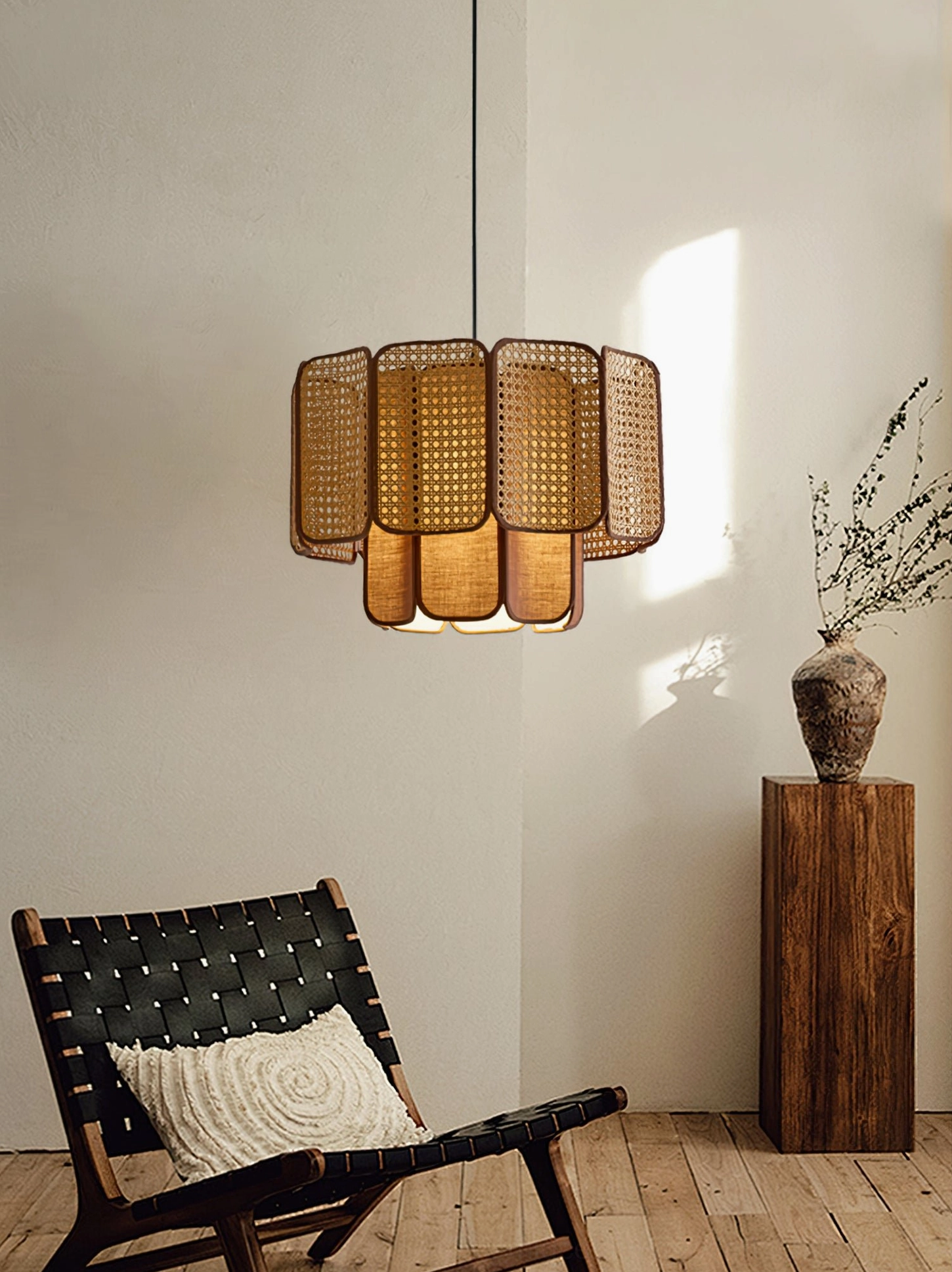 Jaras rattan pendant light in quiet reading corner with accent chair and decorative vase, wabi-sabi aesthetic