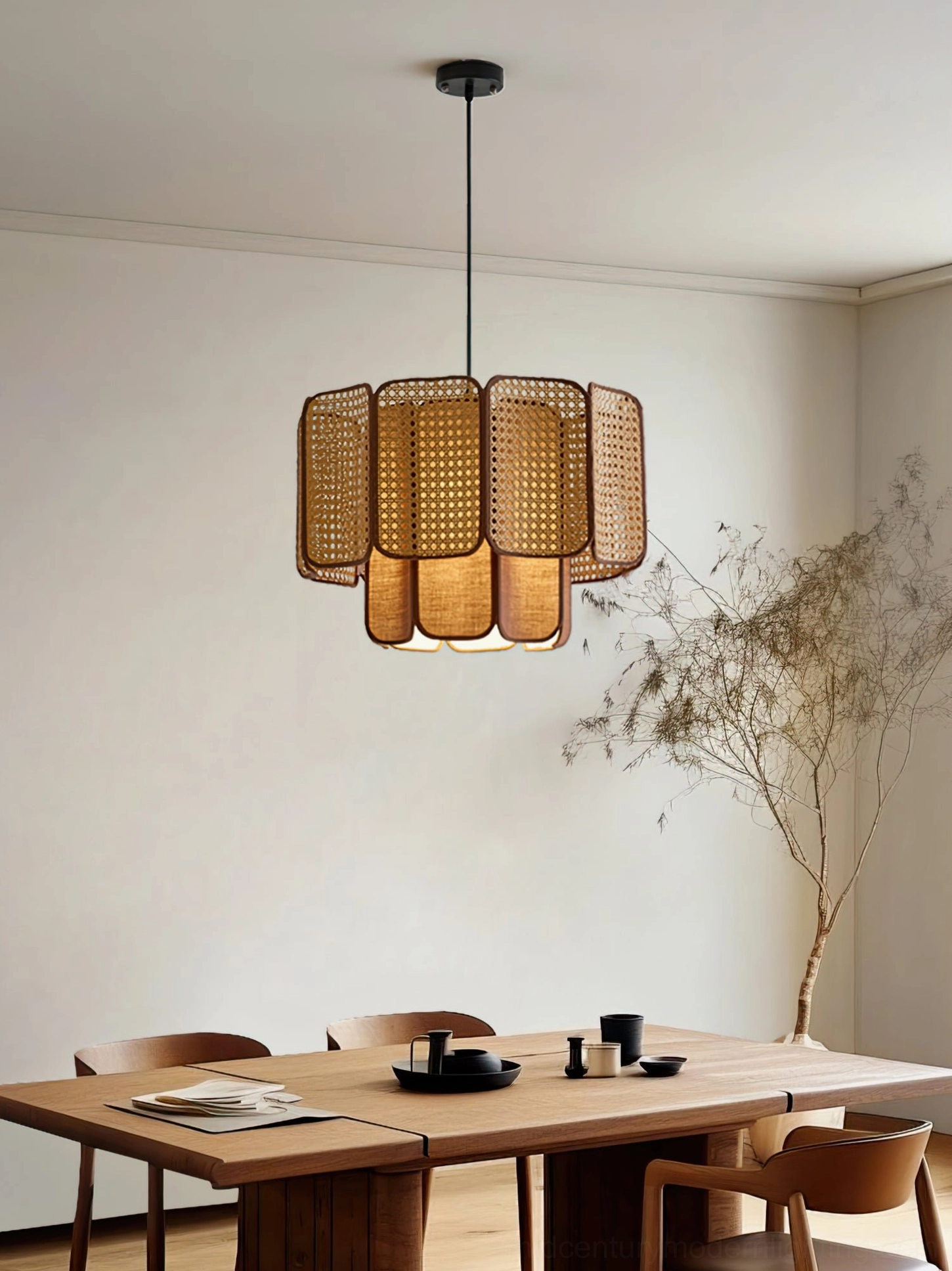 Jaras rattan pendant light three-quarter perspective in minimalist dining room with dried florals and warm ambient lighting