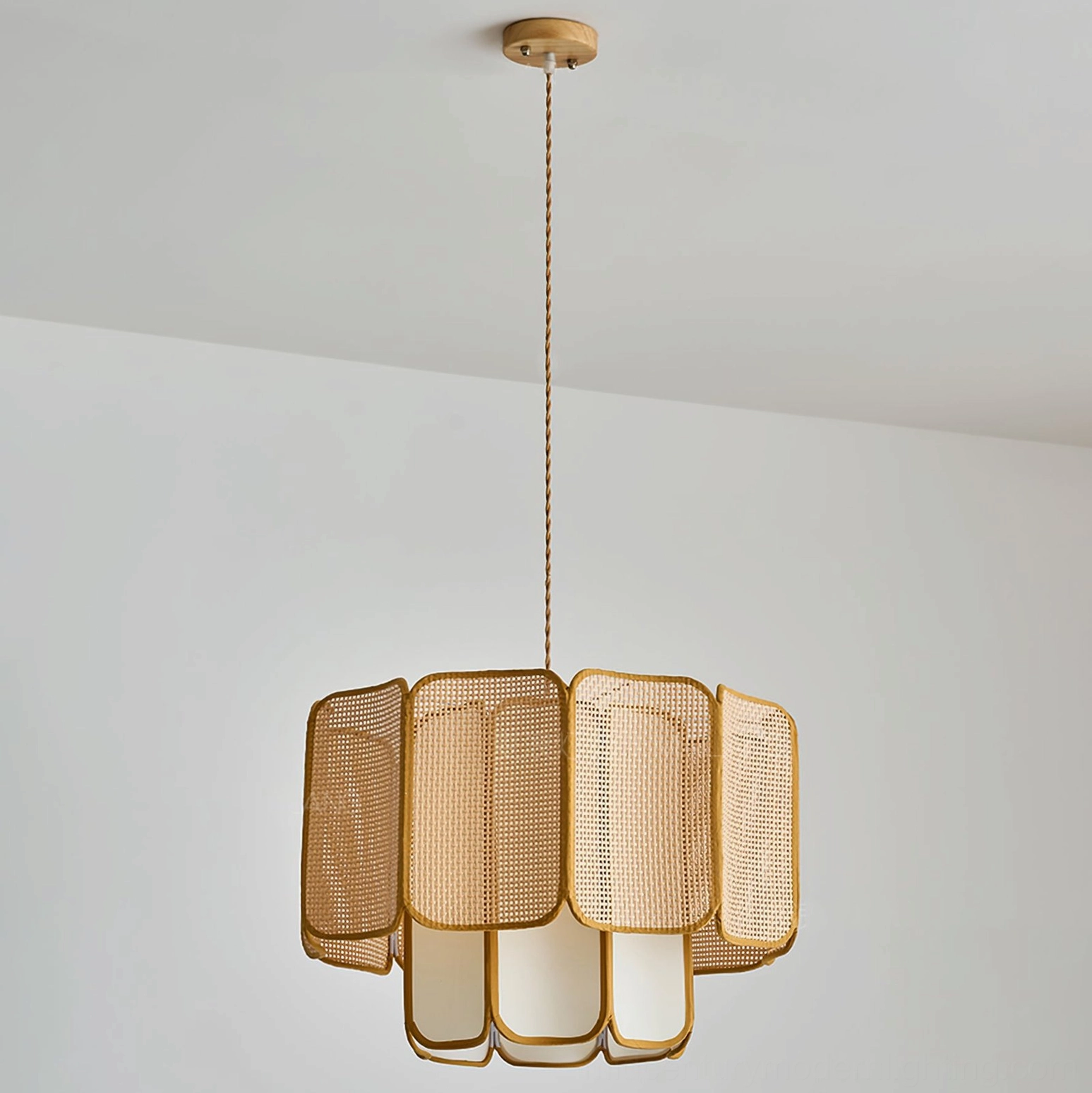 Jaras handwoven rattan pendant light creating shadow patterns on ceiling with organic sculptural form