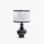 Jarrige ceramic table lamp with black glossy base and white fabric shade, studio front view on white background