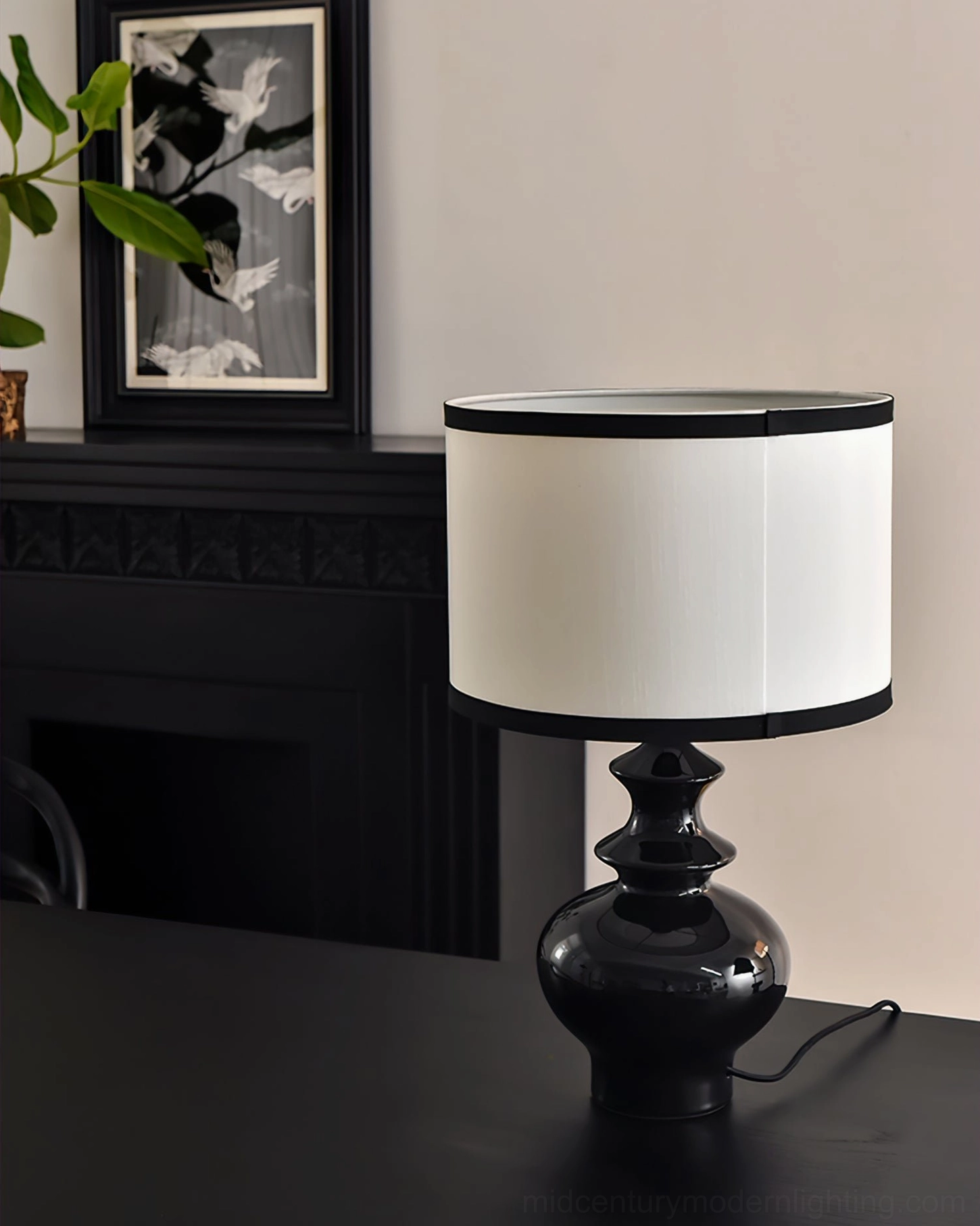 Jarrige table lamp close-up low angle view on fireplace mantel with framed art backdrop, sculptural ceramic base detail