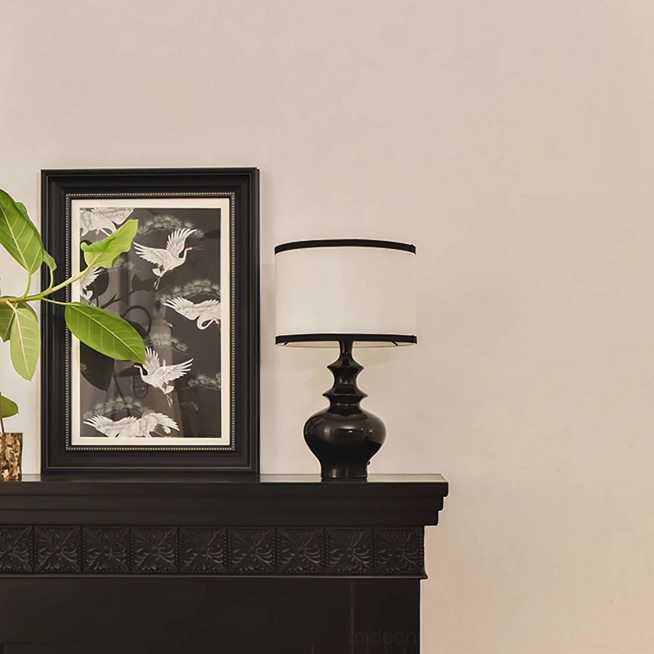 Jarrige table lamp on fireplace with green potted plants, warm minimalist home styling with gallery framing