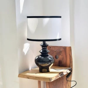 Jarrige mid-century modern table lamp displayed on natural wood side table in classic retro living room setting