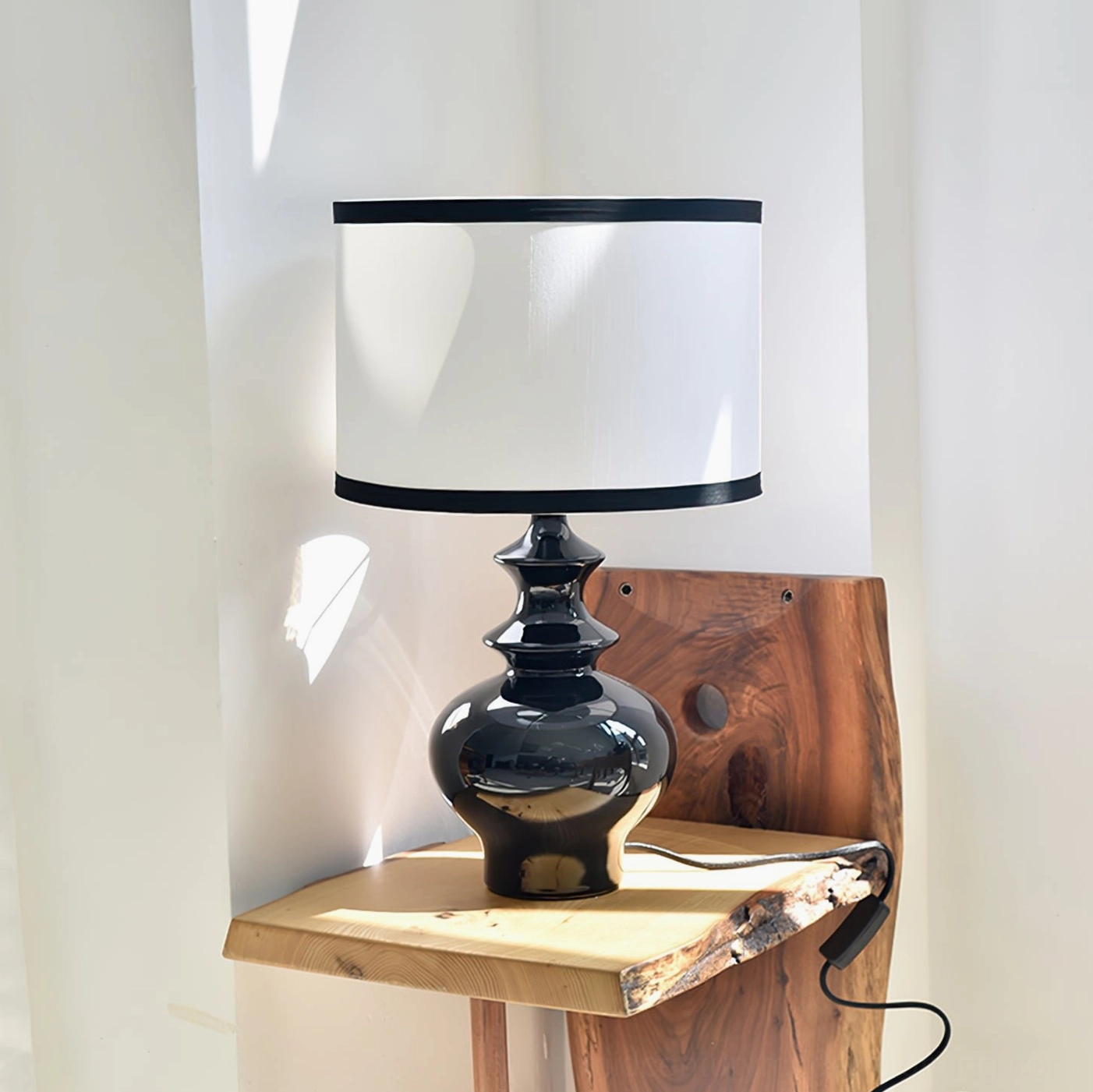 Jarrige mid-century modern table lamp displayed on natural wood side table in classic retro living room setting