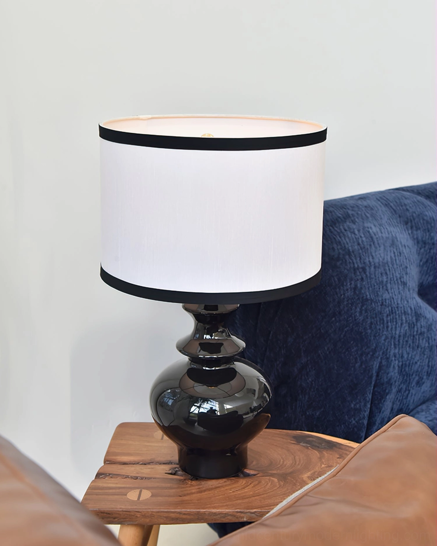 Mid-century modern Jarrige lamp in contemporary living room with sofas and wall art, minimalist design aesthetic