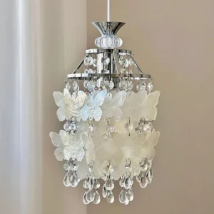 Side close-up detail of Jasinski pendant showing frosted white butterfly decor panels, polished silver hardware and delicate crystal bead chains