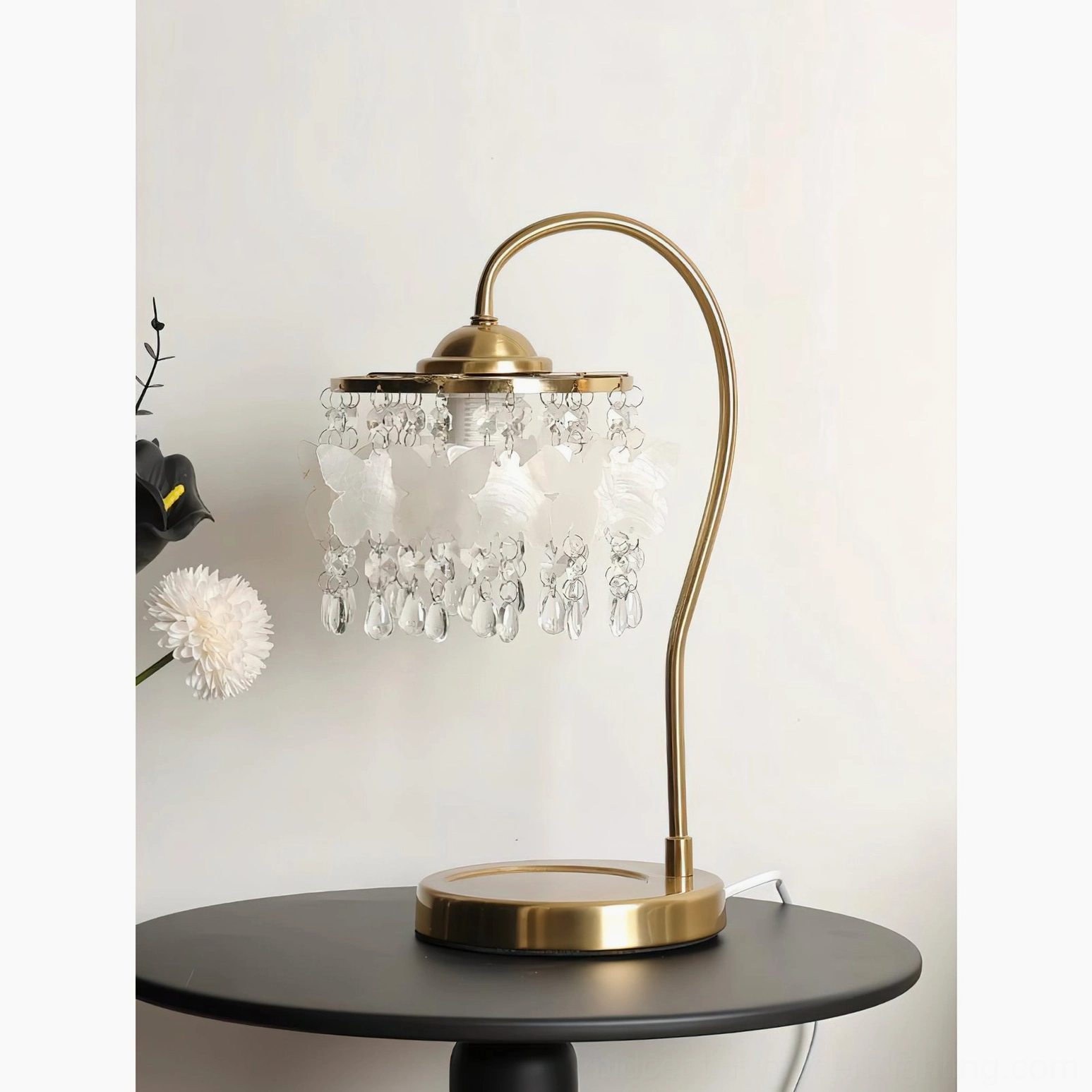 Jasinski crystal butterfly table lamp with white butterfly decorations illuminated on black side table with floral décor