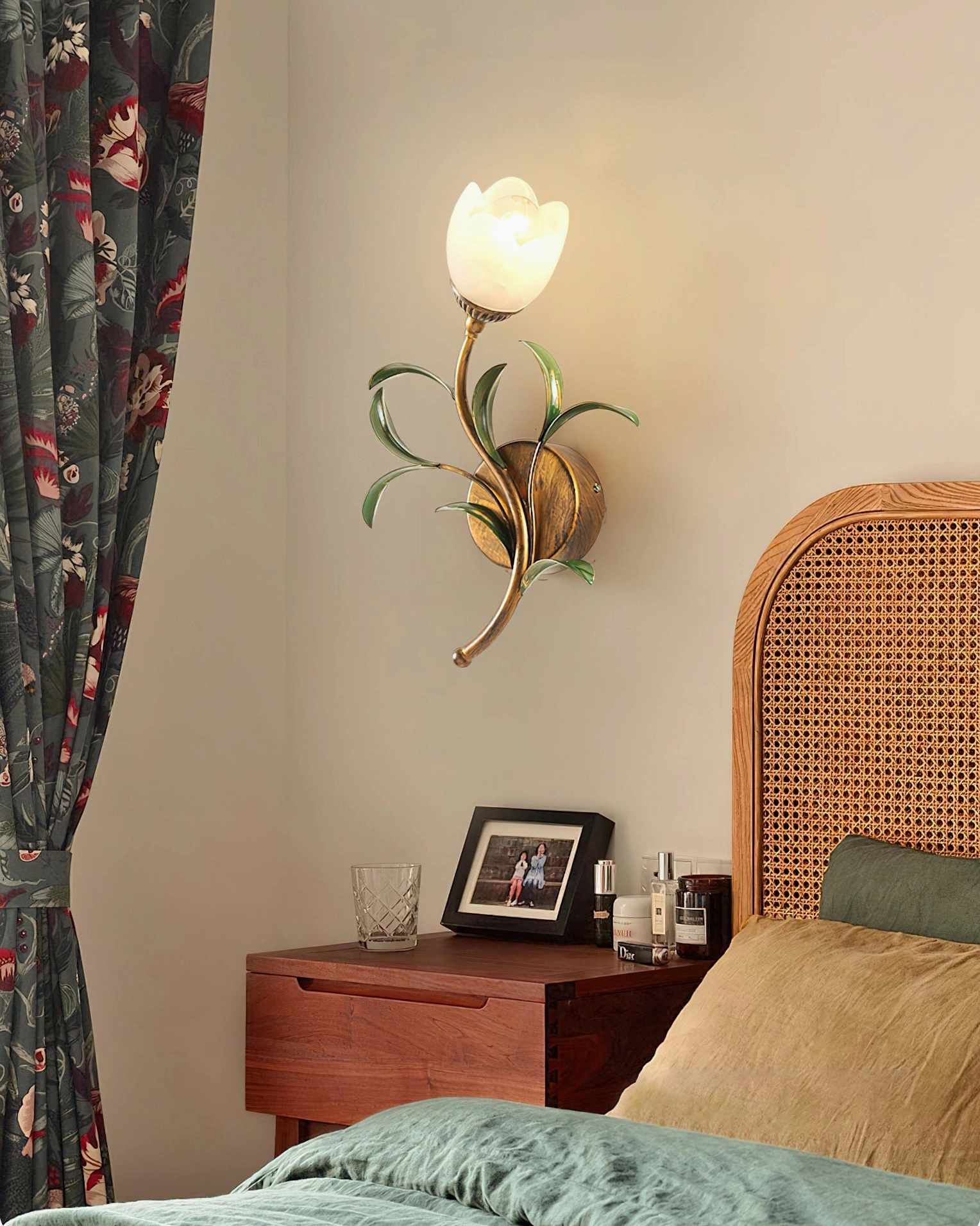 Jasmine single-light wall sconce beside bed creating intimate bedside lighting in master bedroom