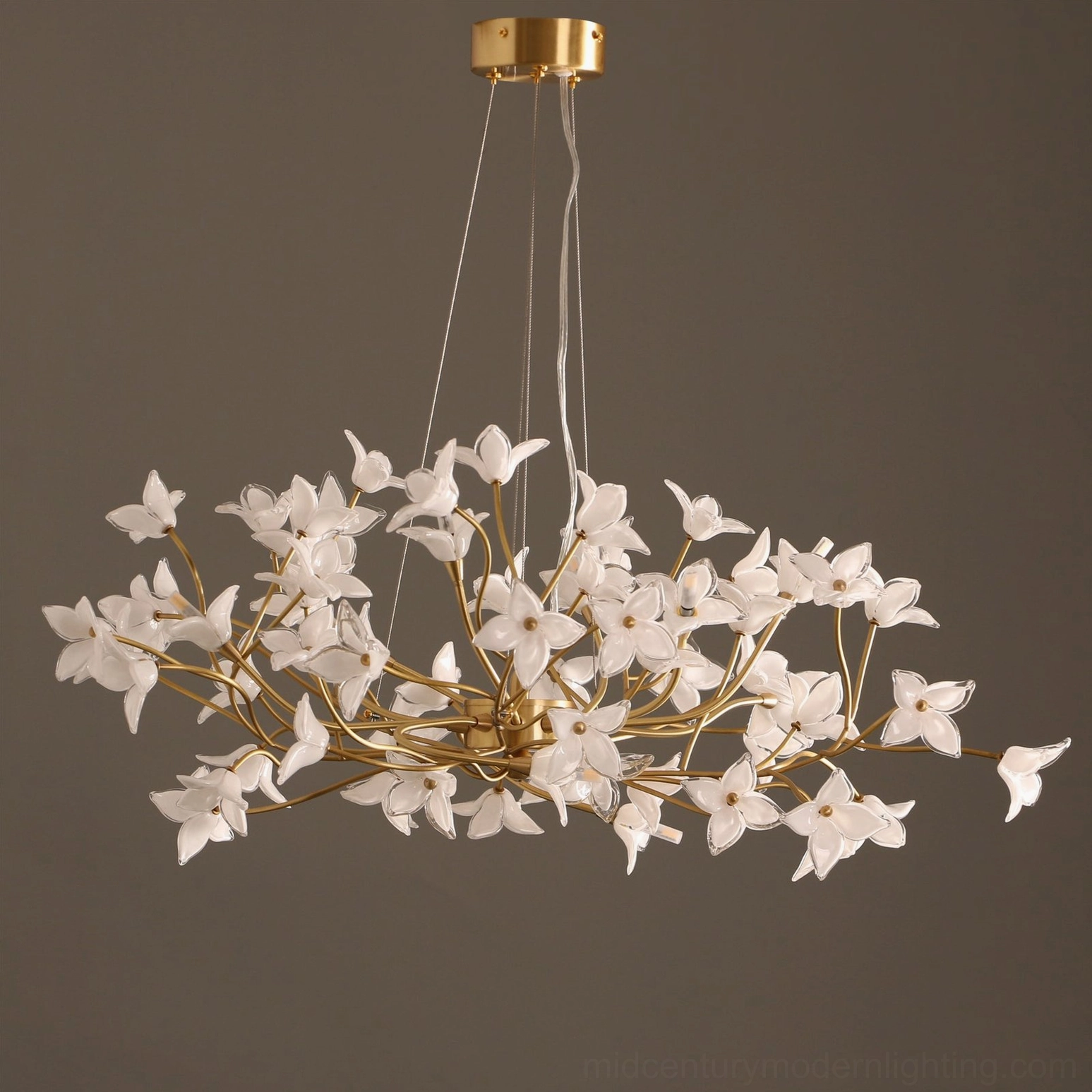 Jasmine Branch Chandelier suspended overhead, casting layered light from glass blooms