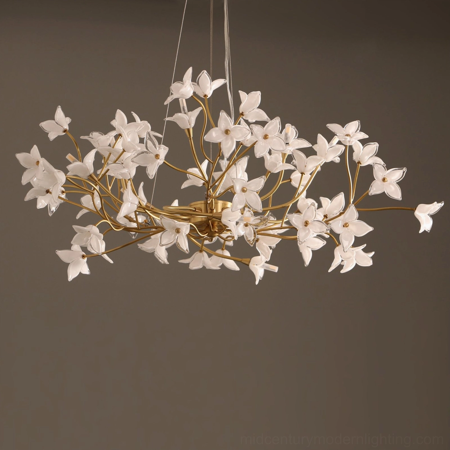 Brass and frosted glass jasmine branch chandelier in contemporary home interior setting