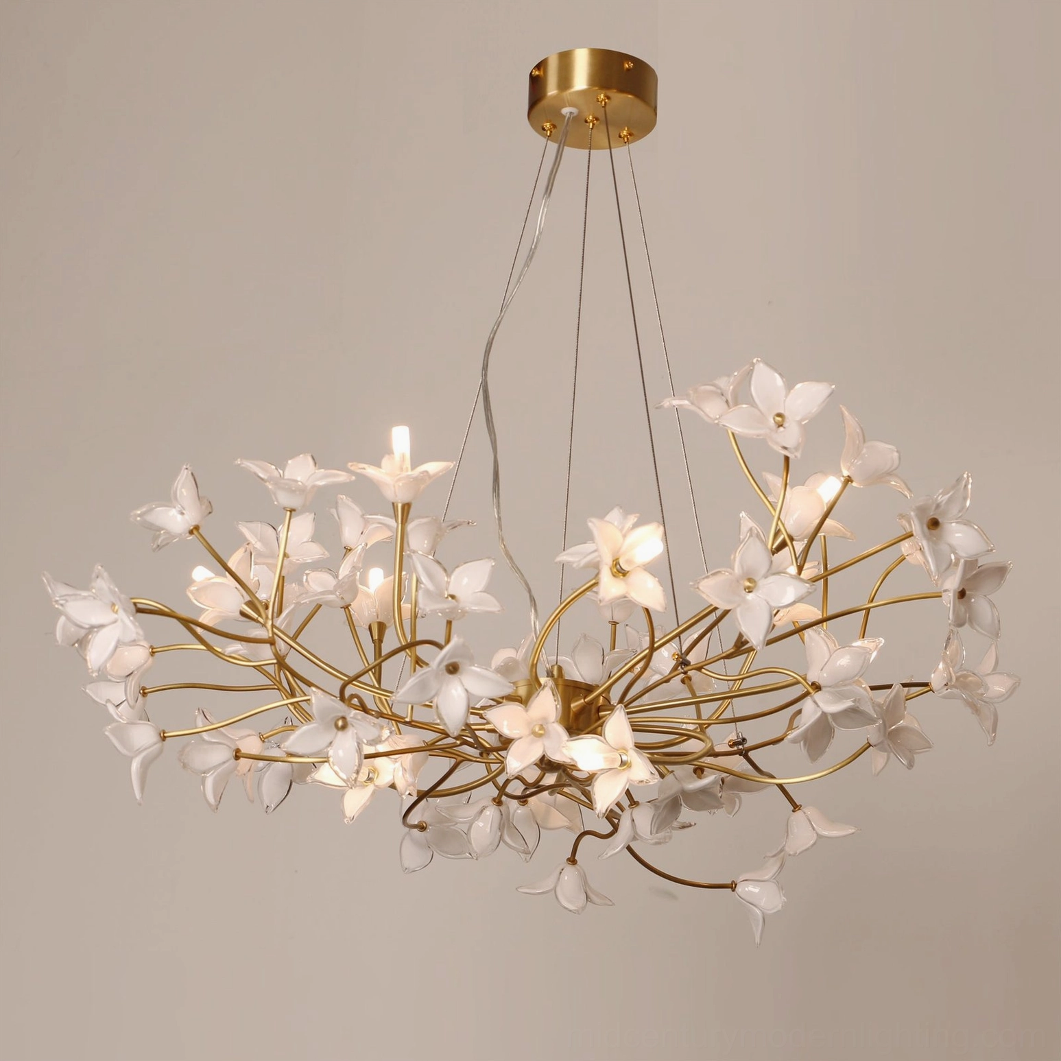 Hand-blown frosted glass jasmine blooms on brass branch framework, close architectural view