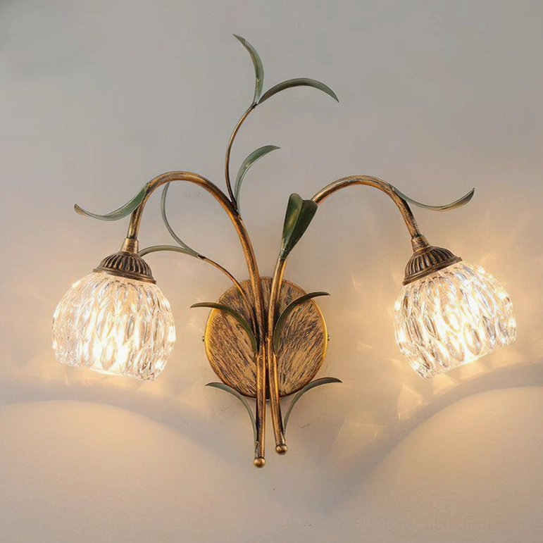 Jasmine model A dual-light wall sconce showing antique brass and frosted glass shade configuration