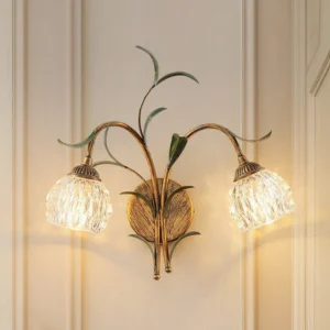 Jasmine wall sconce frontal view showing antique brass frame and textured glass shade detail
