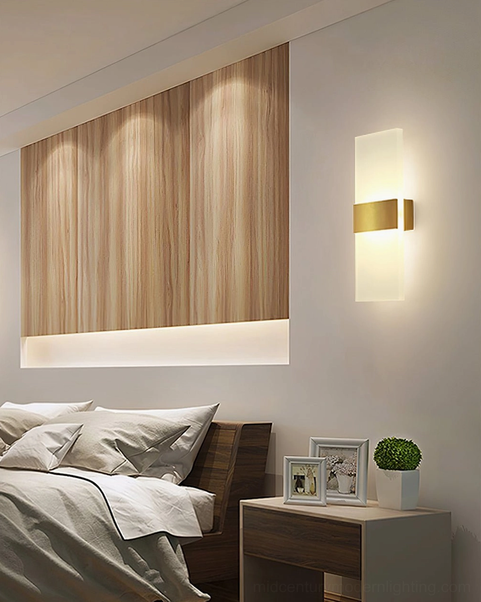 Mid-century wall light with warm brass trim and gentle glowing effect on wood accent wall
