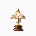 Jenny Butterfly Stained Glass Table Lamp with pink butterfly motifs and walnut wood base, front view on studio background