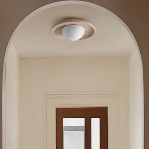 Jenny travertine ceiling light installed in modern arched entryway with warm minimalist interior design aesthetic